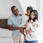 Family of 4 at home during their newborn photography session in Toronto