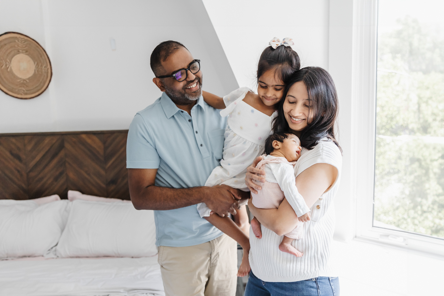 Family of 4 at home during their newborn photography session in Toronto