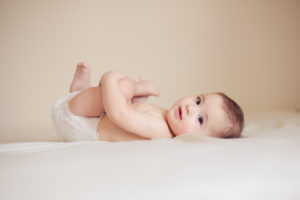 Baby girl laying on her back during Toronto Baby Photography session