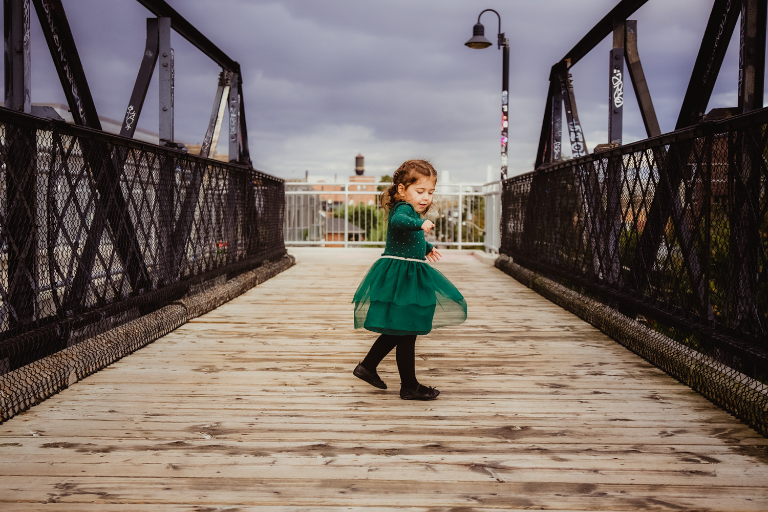 Dance classes in Toronto - little girl twirling on Toronto bridge