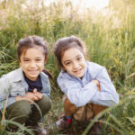 Toronto Summer Camps - two brothers squatting in the tall grass in High Park