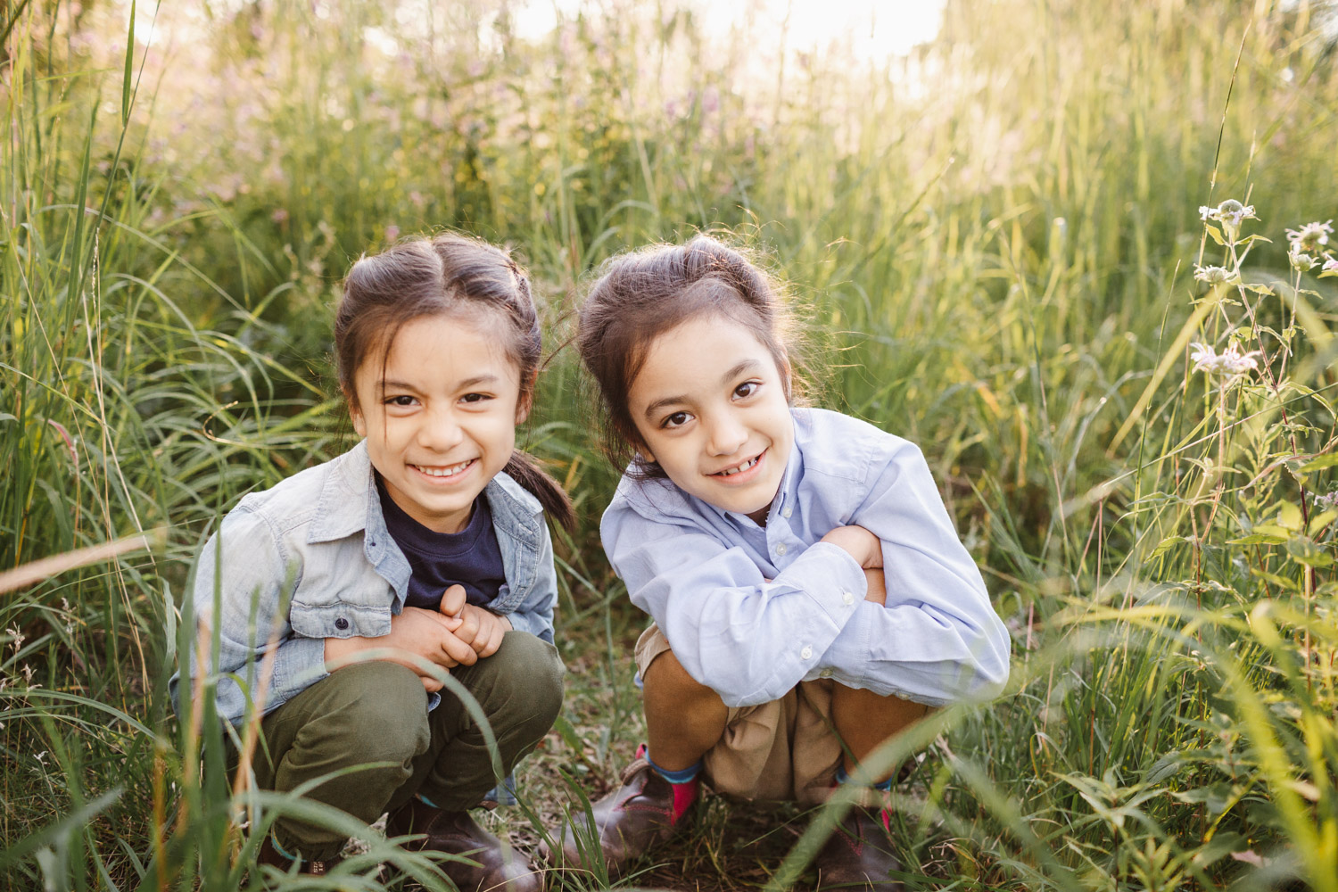 Toronto Summer Camps - two brothers squatting in the tall grass in High Park