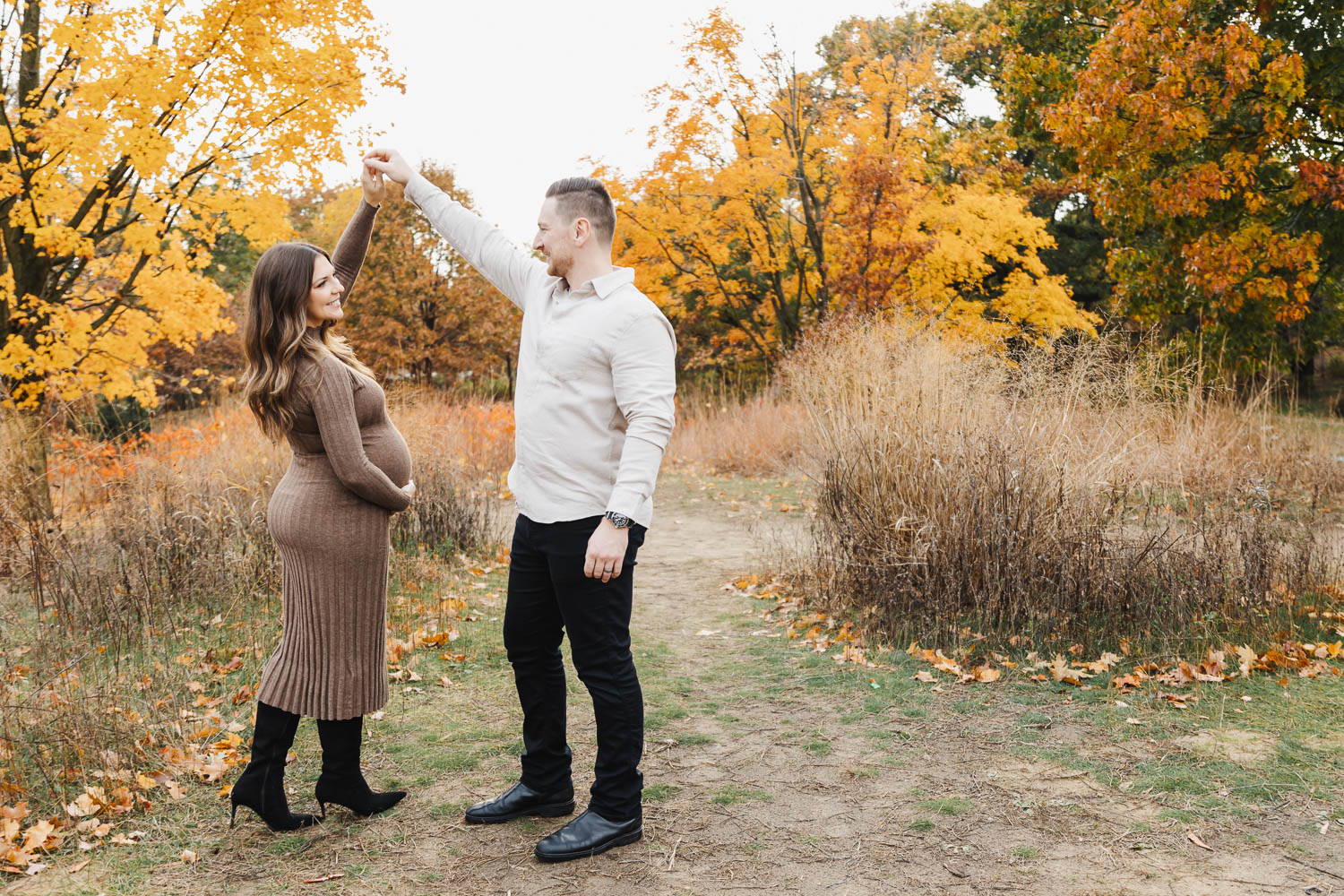 Expecting parents sharing a fun dance during their High Park Maternity Portrait Session