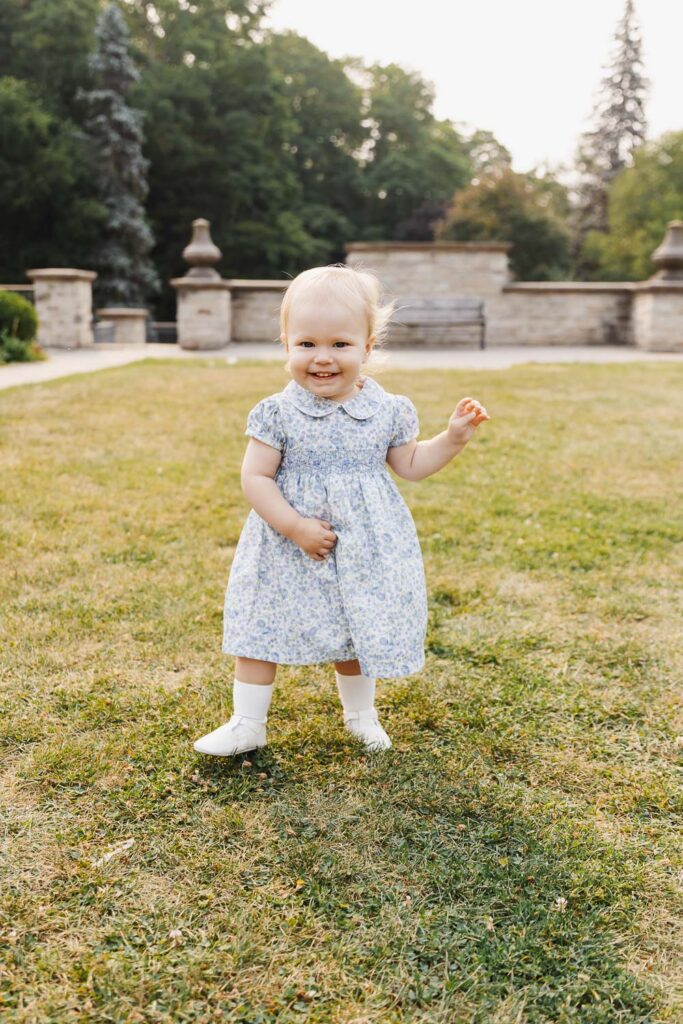 Summer Family Photos at Alexander Muir Memorial Gardens 14 1 year old girl running in grassy area of Toronto Park