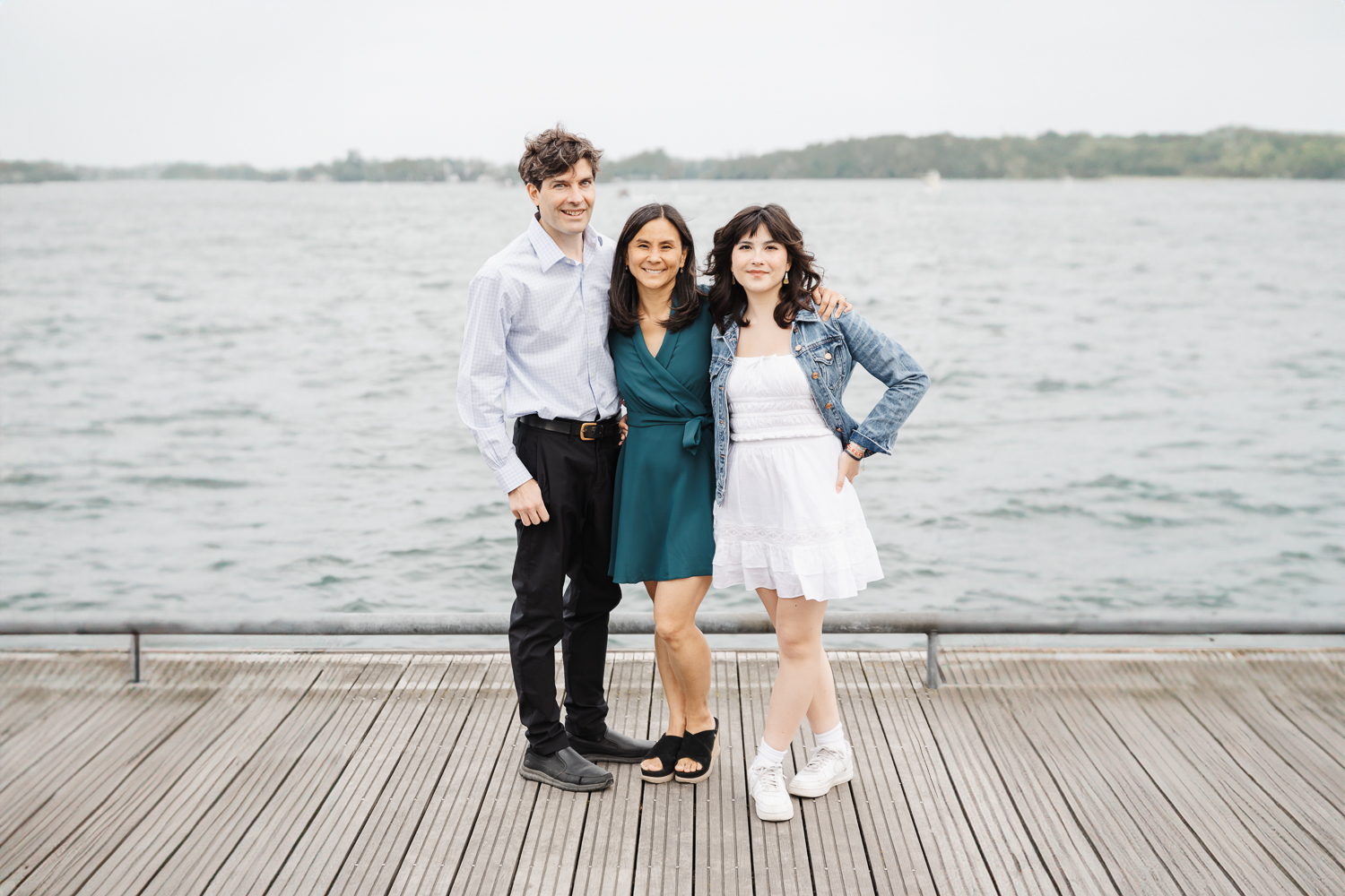 Parents and teen daughter standing on boardwalk at Toronto Harbourfront