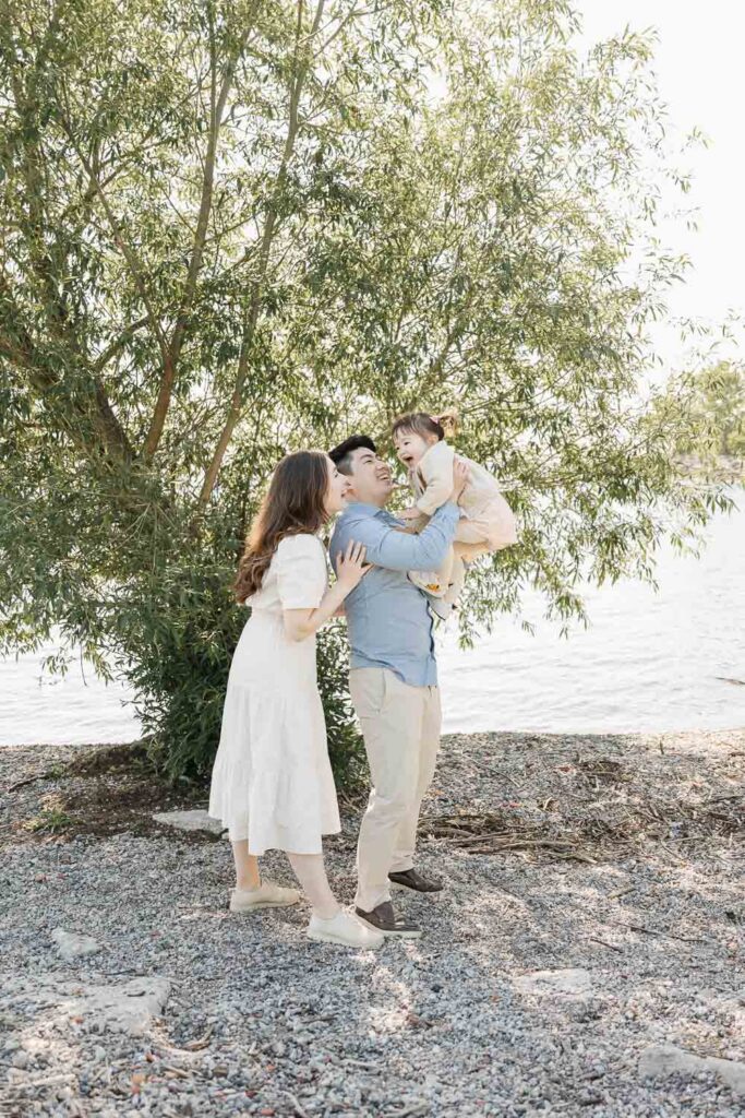 Parents and young daughter enjoying the beach on a summer morning