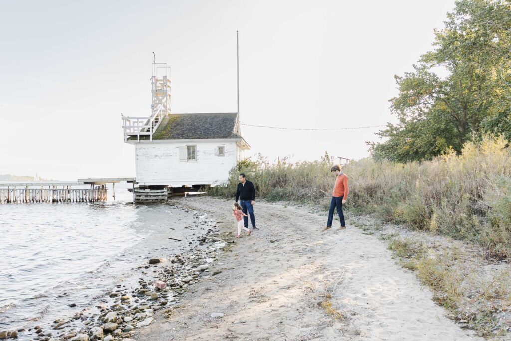 Sunset family portraits at Cherry beach with dads and their daughter