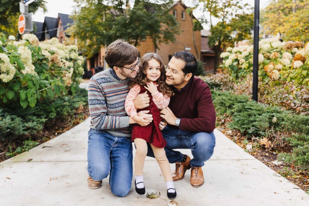 Dads and young daughter enjoying Annex Toronto Park on a fall morning