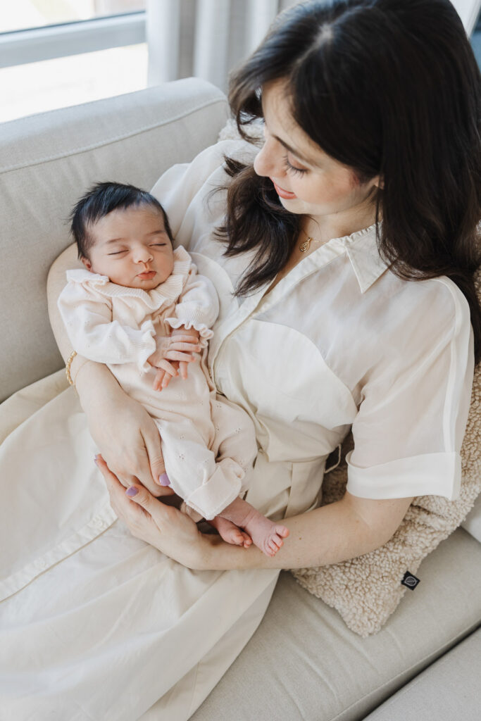 Mom and new daughter snuggling on couch