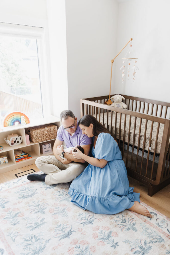 parents holding baby at home Toronto during lifestyle photography session