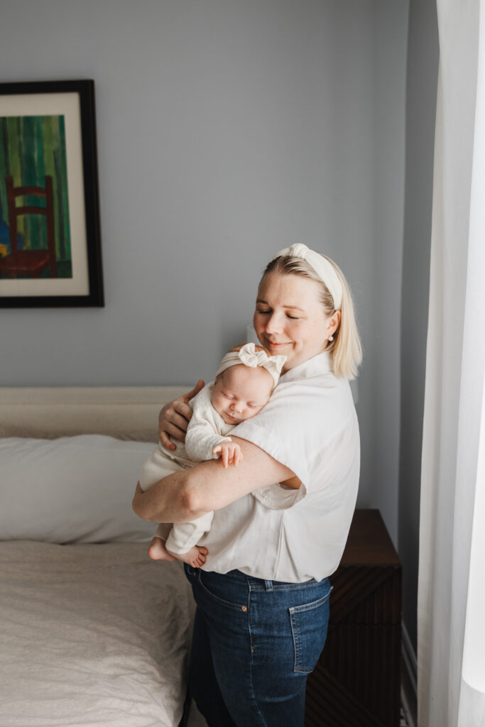 Mom and newborn daughter dressed in matching headbands