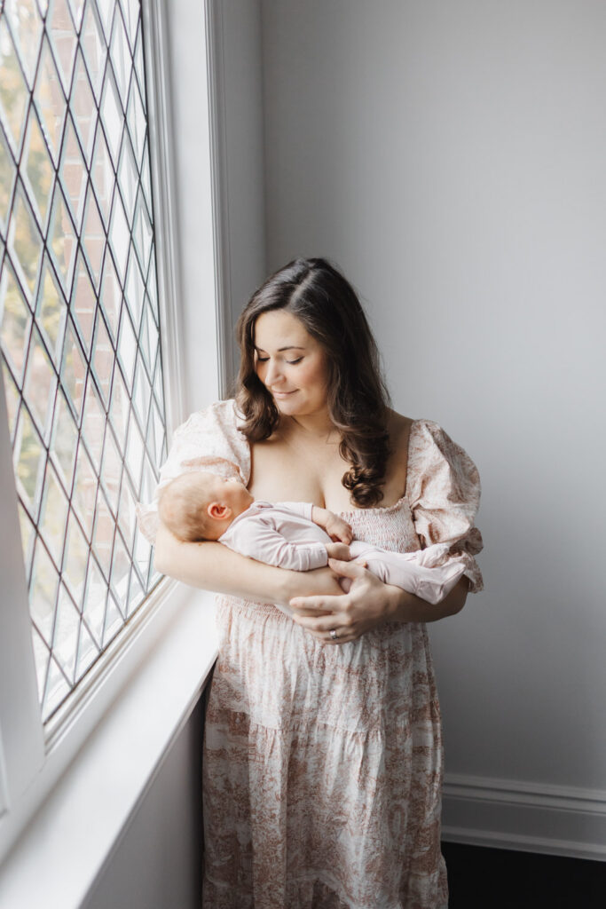 New mom dressed if beautiful flowy pink and cream dress