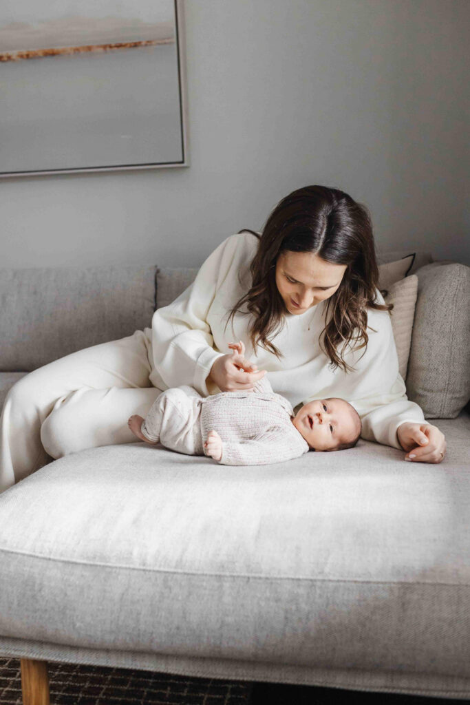 Mom and newborn dressed in cozy knit outfits for their toronto newborn session